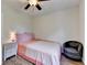 Bright bedroom features a charming single bed, wood-look floors, and a comfortable armchair at 189 Azalea Chase Dr, Suwanee, GA 30024