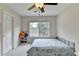 This bedroom has neutral carpet, a ceiling fan, and a built-in shelf unit at 189 Azalea Chase Dr, Suwanee, GA 30024
