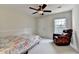 Cozy bedroom featuring plush armchair, neutral carpet, and a ceiling fan for added comfort at 189 Azalea Chase Dr, Suwanee, GA 30024