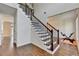Elegant foyer features hardwood floors, a staircase with iron spindles, and natural light at 189 Azalea Chase Dr, Suwanee, GA 30024
