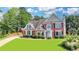 Charming brick home features a well-manicured lawn and established landscaping at 189 Azalea Chase Dr, Suwanee, GA 30024