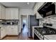 Close up of kitchen featuring granite countertops, mosaic backsplash, and stainless steel appliances at 189 Azalea Chase Dr, Suwanee, GA 30024