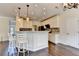 Charming eat-in kitchen with granite counters, mosaic backsplash, white cabinetry, and pendant lighting at 189 Azalea Chase Dr, Suwanee, GA 30024