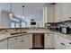 Spacious kitchen with granite counters, stainless dishwasher, and opening to the living room at 189 Azalea Chase Dr, Suwanee, GA 30024