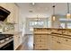 Well-equipped kitchen with granite counters, stainless oven, and opens to the dining area at 189 Azalea Chase Dr, Suwanee, GA 30024