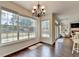 Bright and airy eat-in kitchen with large windows overlooking the backyard, hardwood floors and chandelier at 189 Azalea Chase Dr, Suwanee, GA 30024