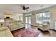 Open-concept living room with hardwood floors and a view into the kitchen at 189 Azalea Chase Dr, Suwanee, GA 30024