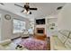 Comfortable living room with a brick fireplace and built-in shelving at 189 Azalea Chase Dr, Suwanee, GA 30024