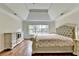 Large main bedroom with hardwood floors, tray ceiling, and a large dresser with ample lighting at 189 Azalea Chase Dr, Suwanee, GA 30024