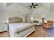 Large main bedroom with tray ceiling, hardwood floors, and sitting area for relaxation at 189 Azalea Chase Dr, Suwanee, GA 30024