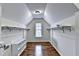 A well-organized walk-in closet with custom shelving and hardwood floors at 189 Azalea Chase Dr, Suwanee, GA 30024