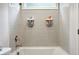 Gray tiled shower/tub combo with organizer rack and window in bright bathroom at 247 Widener Way, Peachtree City, GA 30269