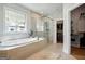 Relaxing bathroom featuring tub, shower and walk-in closet at 247 Widener Way, Peachtree City, GA 30269