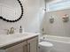 Bright bathroom with a shower-tub combo featuring gray tile surround, a toilet, and a vanity sink at 247 Widener Way, Peachtree City, GA 30269