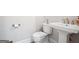Cozy bathroom with a pedestal sink, toilet, and neutral decor at 247 Widener Way, Peachtree City, GA 30269