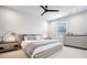 Bright bedroom featuring a gray bed with light-colored bedding, a dresser, and neutral decor at 247 Widener Way, Peachtree City, GA 30269
