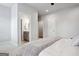 Neutral bedroom featuring gray walls and accents, white bedding, and an ensuite bathroom at 247 Widener Way, Peachtree City, GA 30269