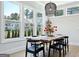 Bright dining room boasting hardwood floors, large windows, a modern light fixture and stylish furniture at 247 Widener Way, Peachtree City, GA 30269