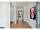 Bright entryway featuring hardwood floors, a modern art piece, and an open view into the living area at 247 Widener Way, Peachtree City, GA 30269