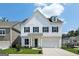 Charming two-story home with white siding, black shutters, and an attached two-car garage at 247 Widener Way, Peachtree City, GA 30269