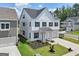 Charming two-story home with a welcoming front porch, manicured lawn, and a three-car garage at 247 Widener Way, Peachtree City, GA 30269