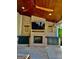 Cozy outdoor fireplace on a covered patio, complete with TV and built-in storage cabinets at 247 Widener Way, Peachtree City, GA 30269