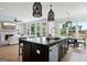 Open concept kitchen with island, stainless steel appliances, and views of the living room and backyard at 247 Widener Way, Peachtree City, GA 30269
