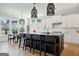 Modern kitchen featuring white cabinets, hardwood floors and a large center island with seating at 247 Widener Way, Peachtree City, GA 30269