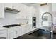 Bright kitchen showcases stainless steel appliances, white cabinets, and a dark countertop island with a sink at 247 Widener Way, Peachtree City, GA 30269