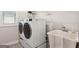 Laundry room equipped with modern appliances and a utility sink at 247 Widener Way, Peachtree City, GA 30269