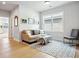 Cozy living room featuring a comfortable sofa, a large window, and a serene atmosphere for relaxation at 247 Widener Way, Peachtree City, GA 30269