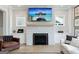 Bright living room with a stone fireplace, a modern TV, and comfortable seating, creating a cozy space at 247 Widener Way, Peachtree City, GA 30269
