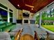 This covered patio includes outdoor seating, a fan, and a fireplace with a TV, perfect for entertaining at 247 Widener Way, Peachtree City, GA 30269