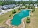Aerial view shows the beautiful pond and landscaping of the neighborhood at 247 Widener Way, Peachtree City, GA 30269