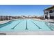 Inviting community swimming pool with lap lanes and a clear blue sky overhead, creating a perfect spot for relaxation and exercise at 247 Widener Way, Peachtree City, GA 30269