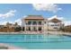 Community swimming pool with a building, perfect for relaxation and recreation on a sunny day at 247 Widener Way, Peachtree City, GA 30269