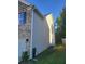 Side of home shows neutral siding and brick accents, adjacent to green lawn at 3675 Brookhollow Dr, Douglasville, GA 30135