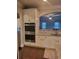 Kitchen with double oven, white cabinets, granite countertops, and an island at 3675 Brookhollow Dr, Douglasville, GA 30135