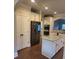 Kitchen features a stainless refrigerator, island, and white cabinets at 3675 Brookhollow Dr, Douglasville, GA 30135