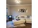 Bright living room featuring white sectional, throw pillows, and modern artwork at 3675 Brookhollow Dr, Douglasville, GA 30135