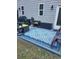 A close-up of a modern patio featuring a rug and various seating and decor at 3675 Brookhollow Dr, Douglasville, GA 30135