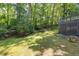 Lush backyard with mature trees, a grassy lawn, and a wooden lattice deck perfect for outdoor relaxation at 1172 Colony Dr, Marietta, GA 30068