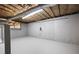 Unfinished basement offers potential for customization with exposed ceiling and painted concrete walls and floor at 1172 Colony Dr, Marietta, GA 30068