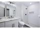 This updated bathroom features a double sink vanity and a beautifully tiled walk-in shower at 1172 Colony Dr, Marietta, GA 30068