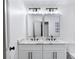 This renovated bathroom includes a dual sink vanity with stone countertops and sleek black fixtures at 1172 Colony Dr, Marietta, GA 30068