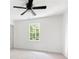This bedroom includes neutral carpeting, a ceiling fan, and a view of the outdoors at 1172 Colony Dr, Marietta, GA 30068