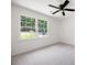 Bright bedroom with neutral carpeting, a ceiling fan, and a window with green outdoor views at 1172 Colony Dr, Marietta, GA 30068