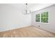A formal dining room featuring new hardwood floors and modern chandelier lighting at 1172 Colony Dr, Marietta, GA 30068