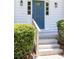 Welcoming entryway featuring a blue front door with glass accents, framed by elegant sconces and lush greenery at 1172 Colony Dr, Marietta, GA 30068