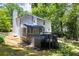 Exterior view of the home with a dark wood deck, screened porch, and lush landscaping at 1172 Colony Dr, Marietta, GA 30068